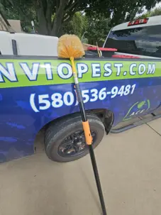 Webster leaning on Environmental Pest Control labeled truck